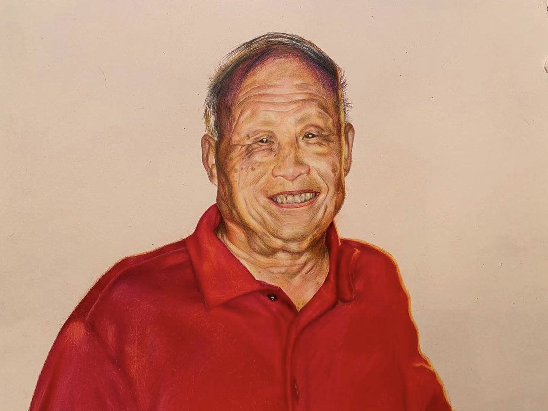 Portrait of a smiling older man in a red polo shirt