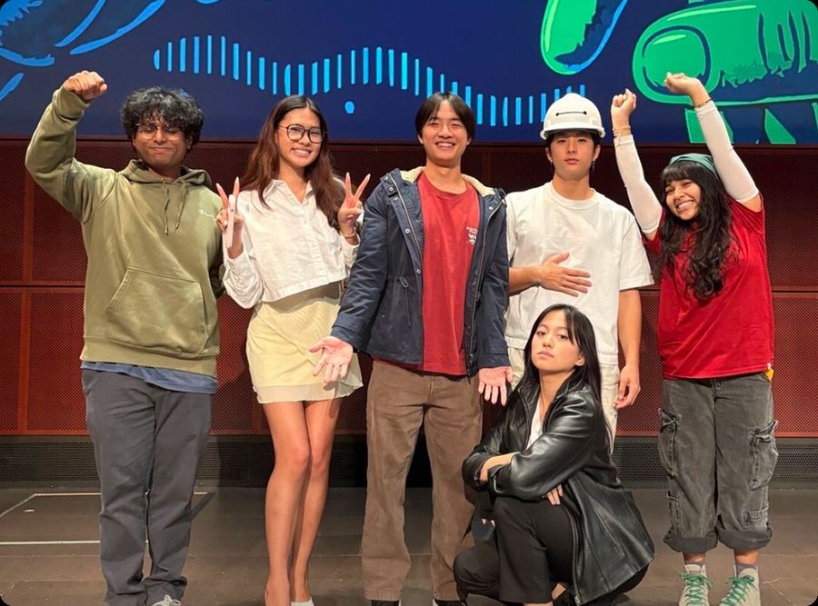 The winning hackathon team posing on stage