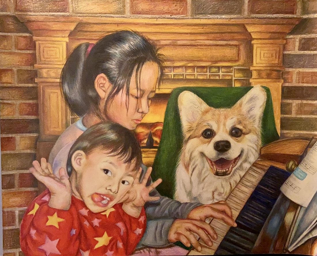 Two children at a piano beside a smiling corgi, in front of a brick fireplace